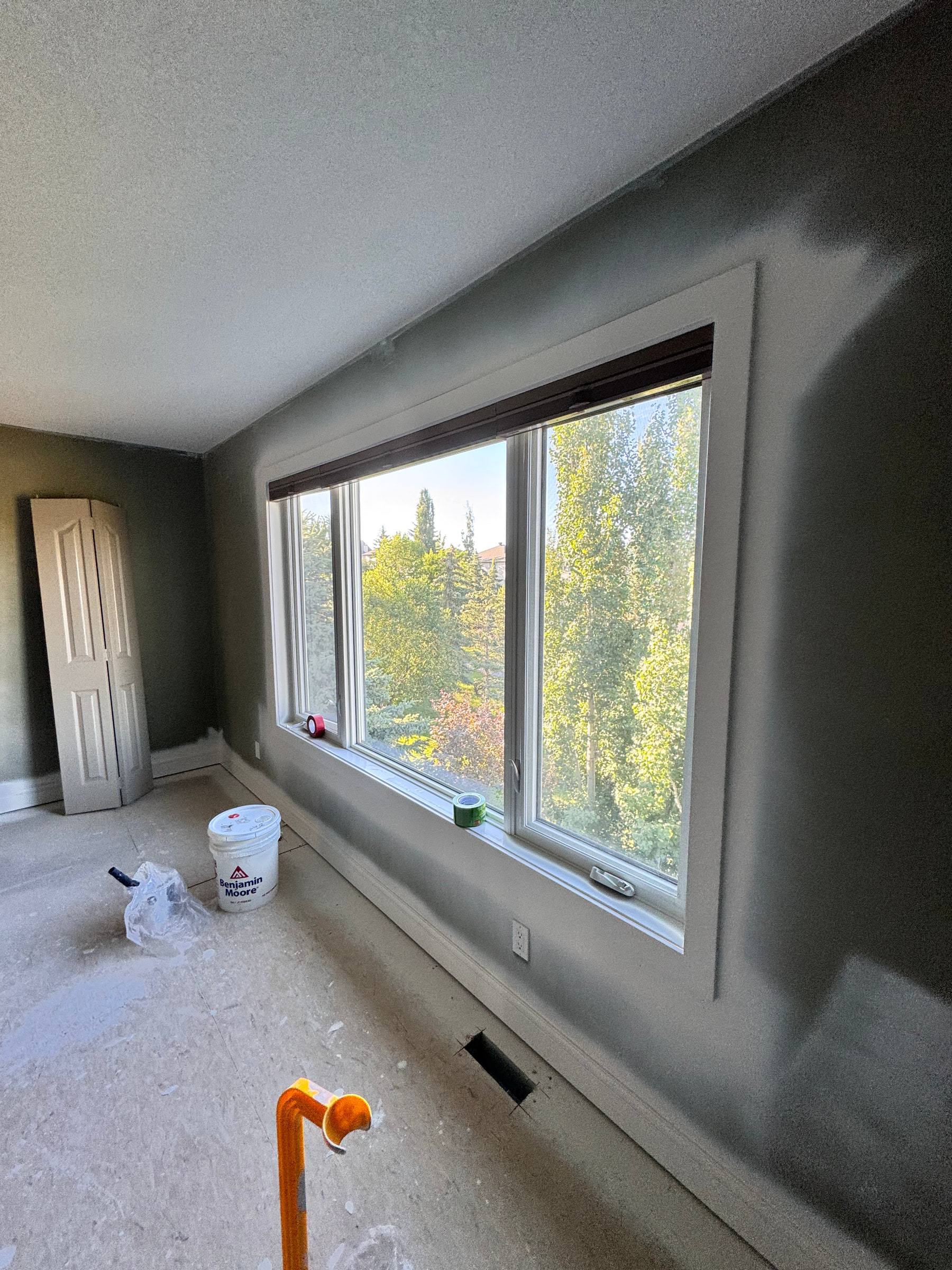 Large bedroom window with new wide casing and a continuous sill