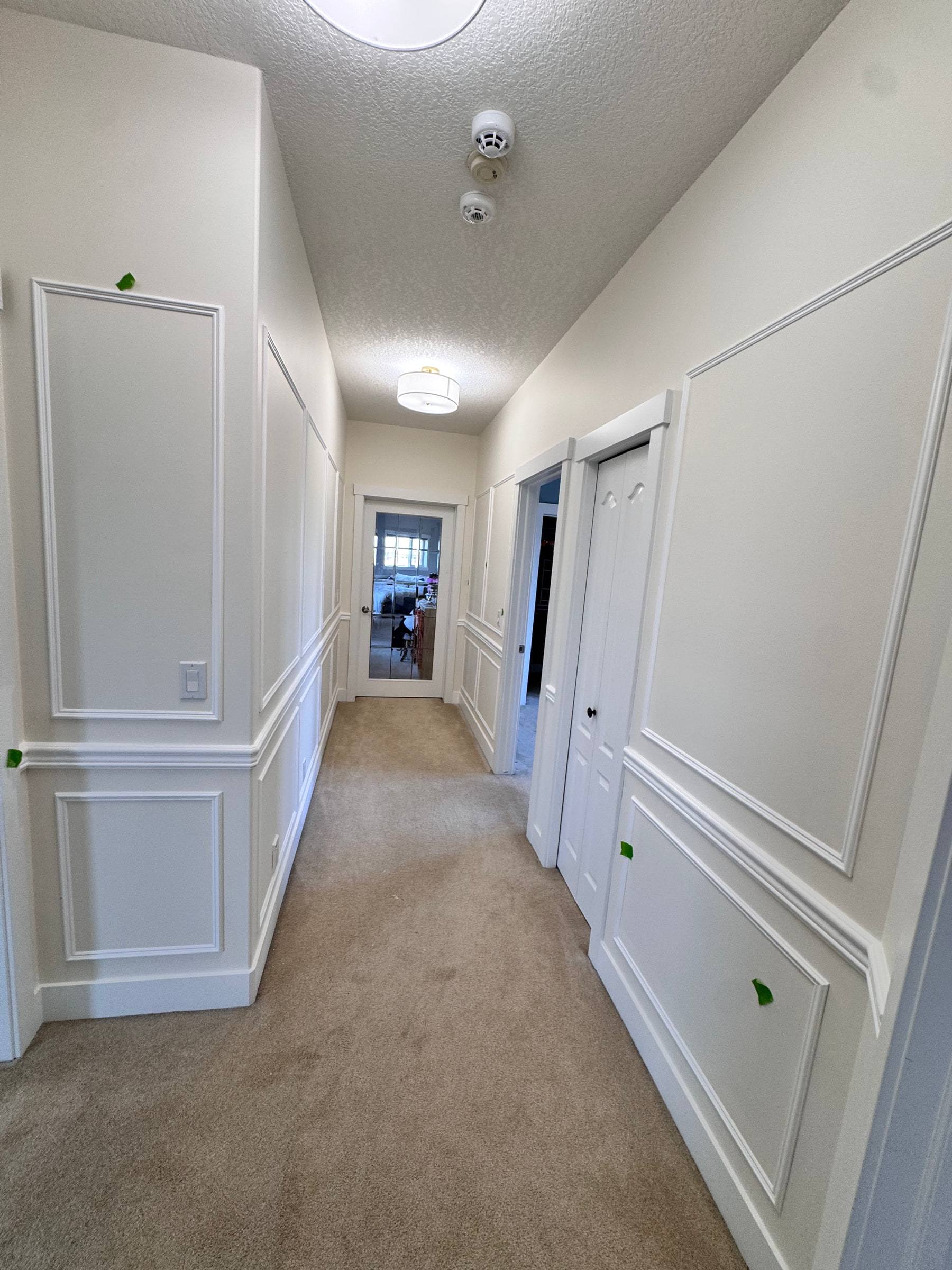 Upstairs hallway with full-height panel moulding above and below a chair rail