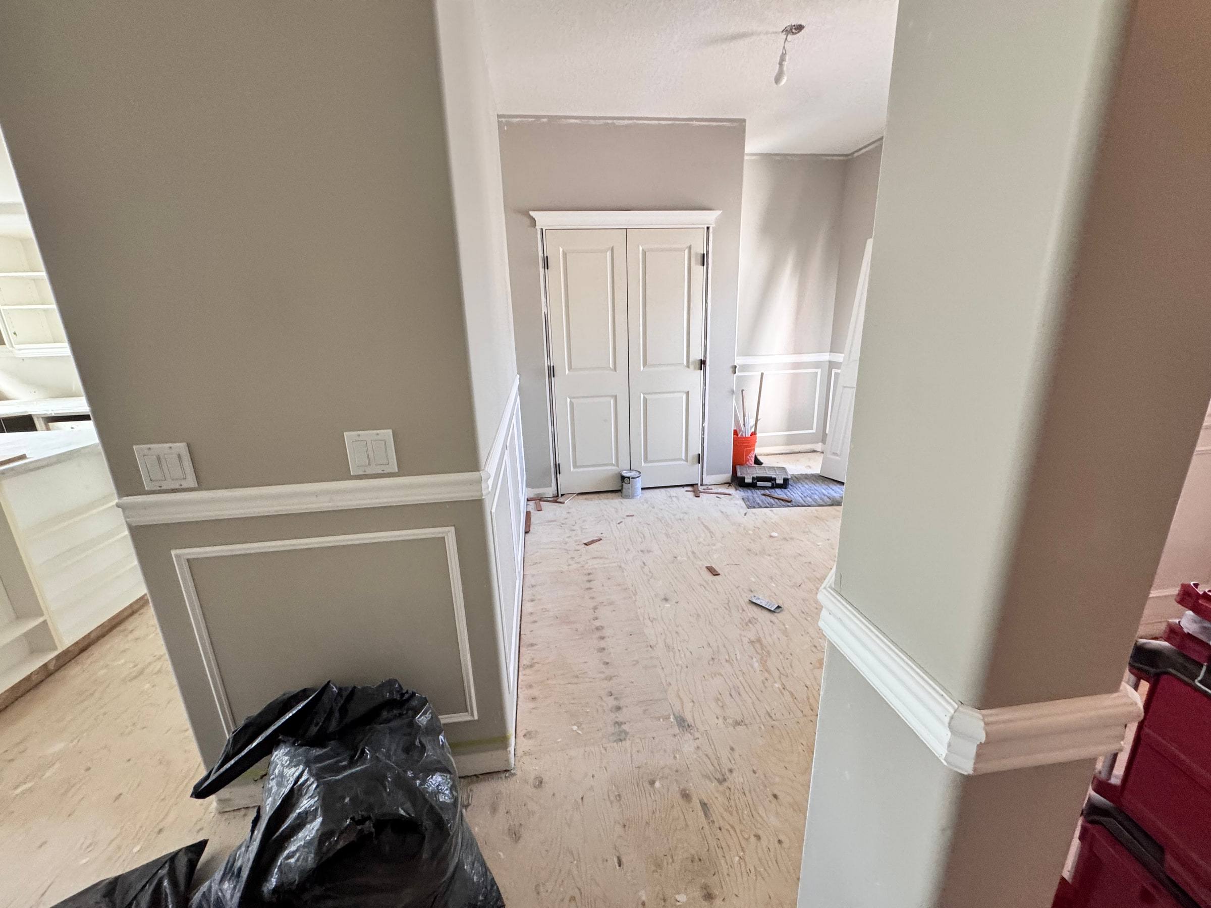 Wainscoting wrapped around a column and along a wall during the renovation
